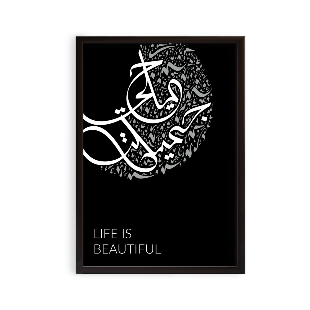 Arabic art print in a black frame. Black background with white and grey text. English typed: "LIFE IS BEAUTIFUL" and Arabic handwritten: "Hayaatun Jameelatun"